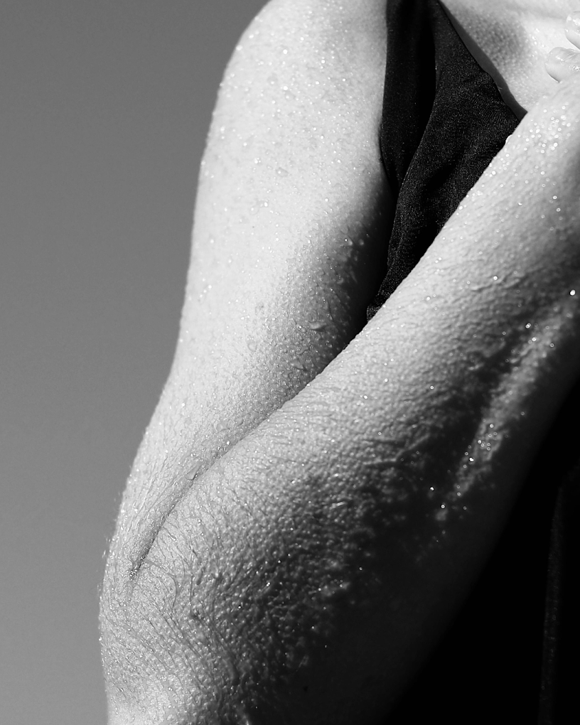Close-up of sweat-beaded skin after a hot class